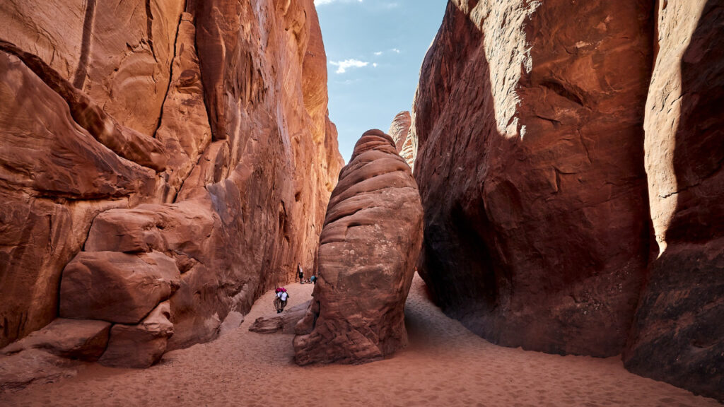 Desert hiking trail with red rock arches landscape