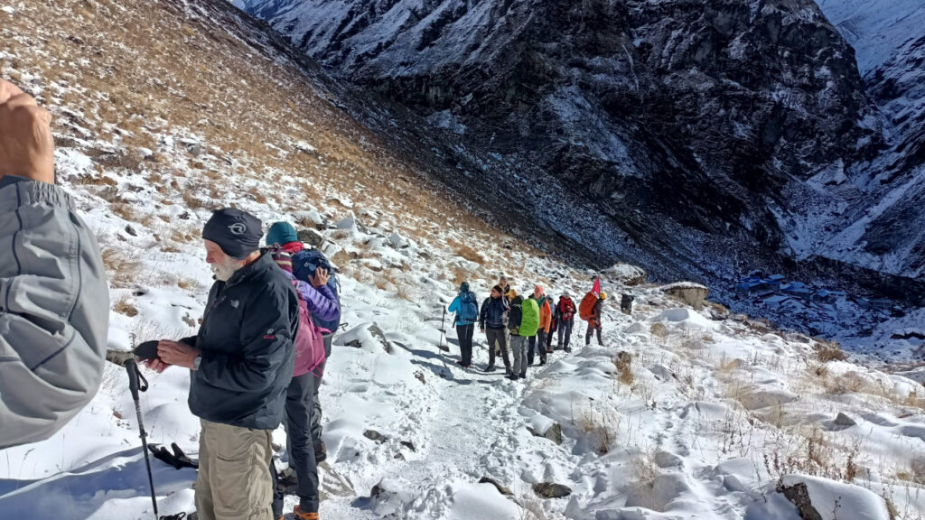 Trekker walking through Manang village landscape