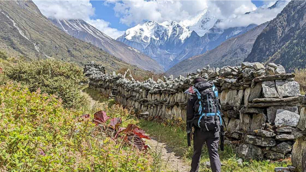 Trekker walking along hillside path